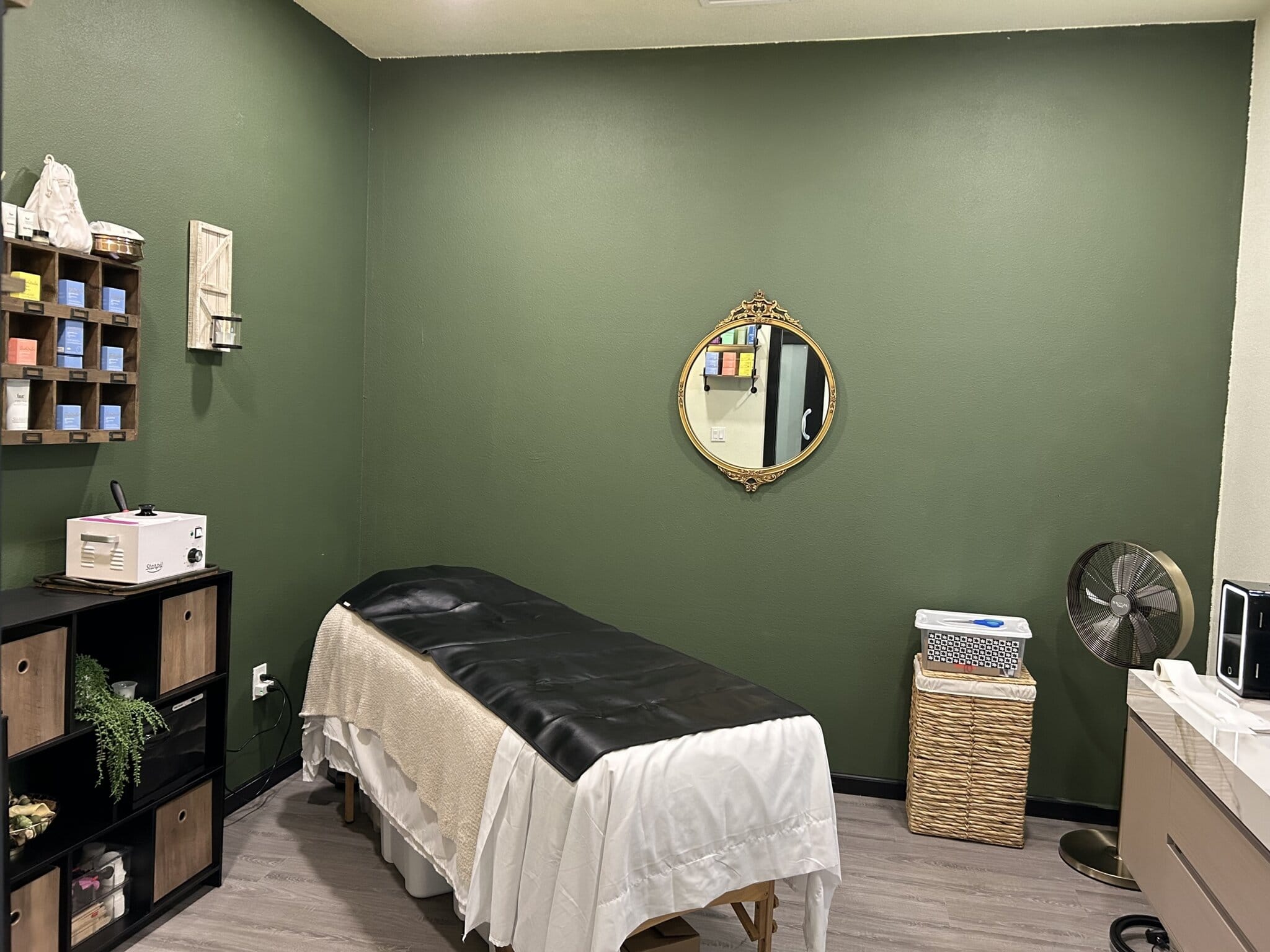 Comfortable massage table, cozy decor, and professional ambiance.