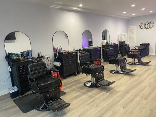 Stylish salon workspace with comfortable black chairs, mirrors, and organized styling tools for salon rental.