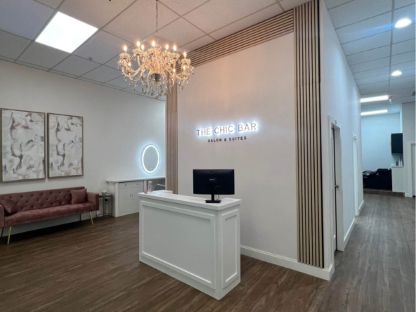 Elegant salon reception with chandelier and stylish decor.