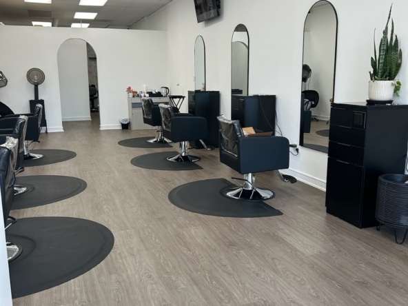 Clean, stylish salon with individual stations, mirrors, and professional lighting for rent.