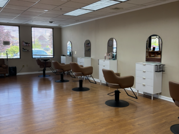 Bright salon interior with styling stations, mirrors, and chairs at Salon Renter.