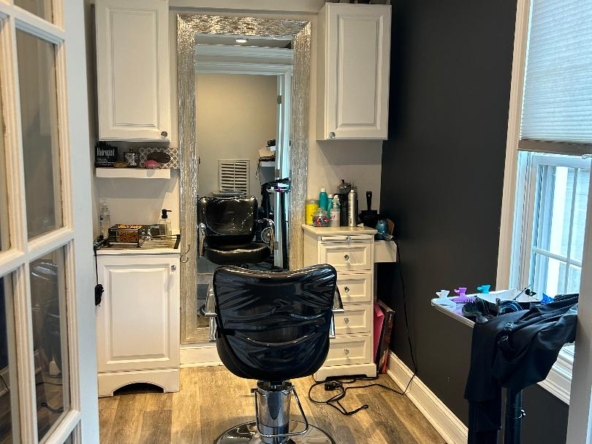 Elegant salon workspace with styling chair, mirror, and professional salon equipment.
