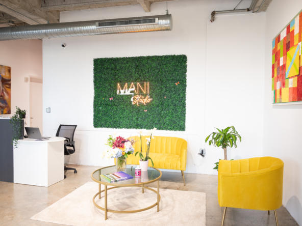 Modern salon reception area with stylish decor, vibrant colors, and greenery for salon rental business.