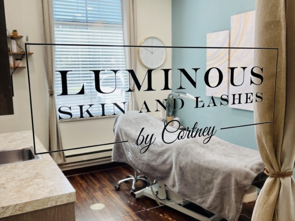 Bright treatment room with massage bed and large window at Luminous Skin and Lashes by Cortney.