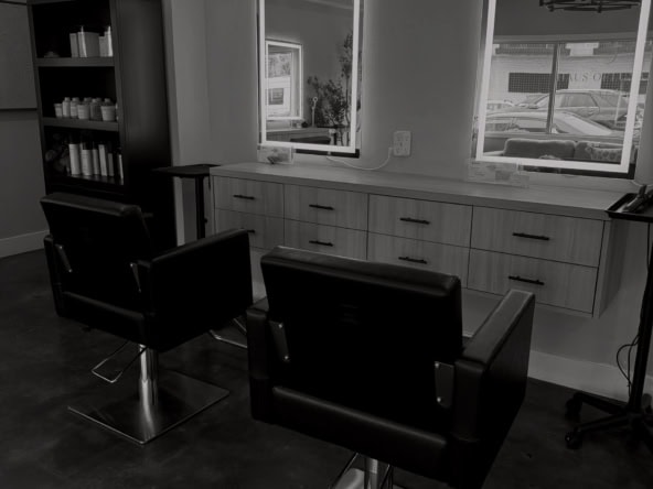 Clean, professional salon interior with styling chairs and mirrors for hair services.