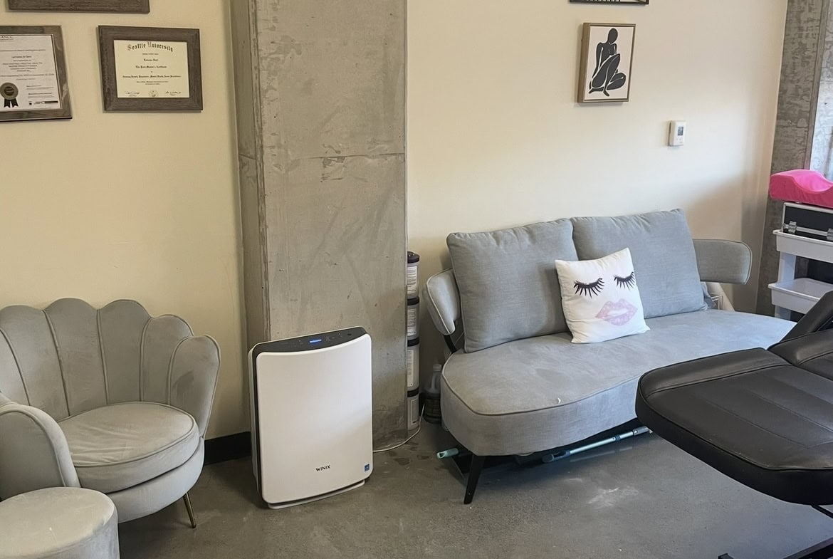 Salon Renter waiting area with comfortable chairs and stylish decor.