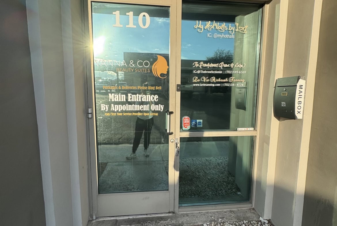 Main entrance door to Salon Renter with glass door and signage, located at 110.