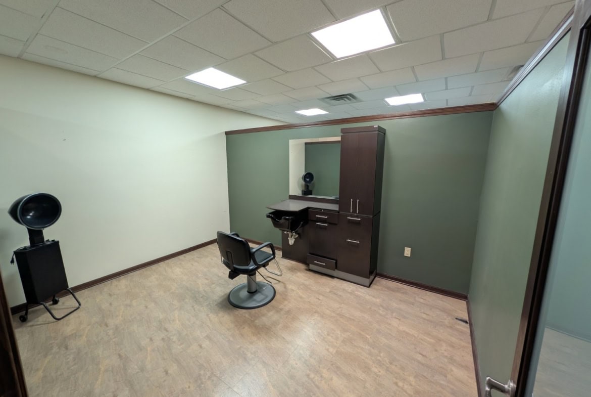 Hair salon station with mirror, styling chair, and hairdressing equipment in a professional salon en.