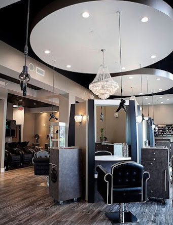 Stylish salon interior with modern decor, lighting, and comfortable styling stations.