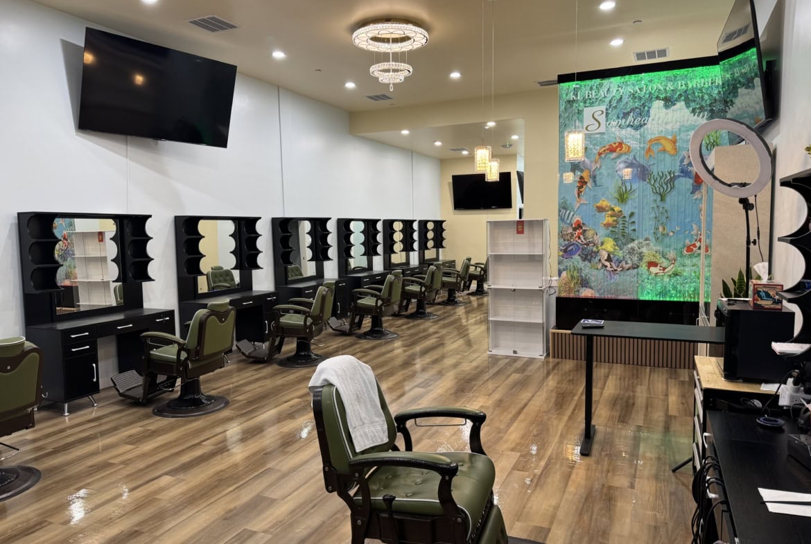 Hair salon workspace with styling stations, mirrors, and vibrant aquatic-themed wall decor.