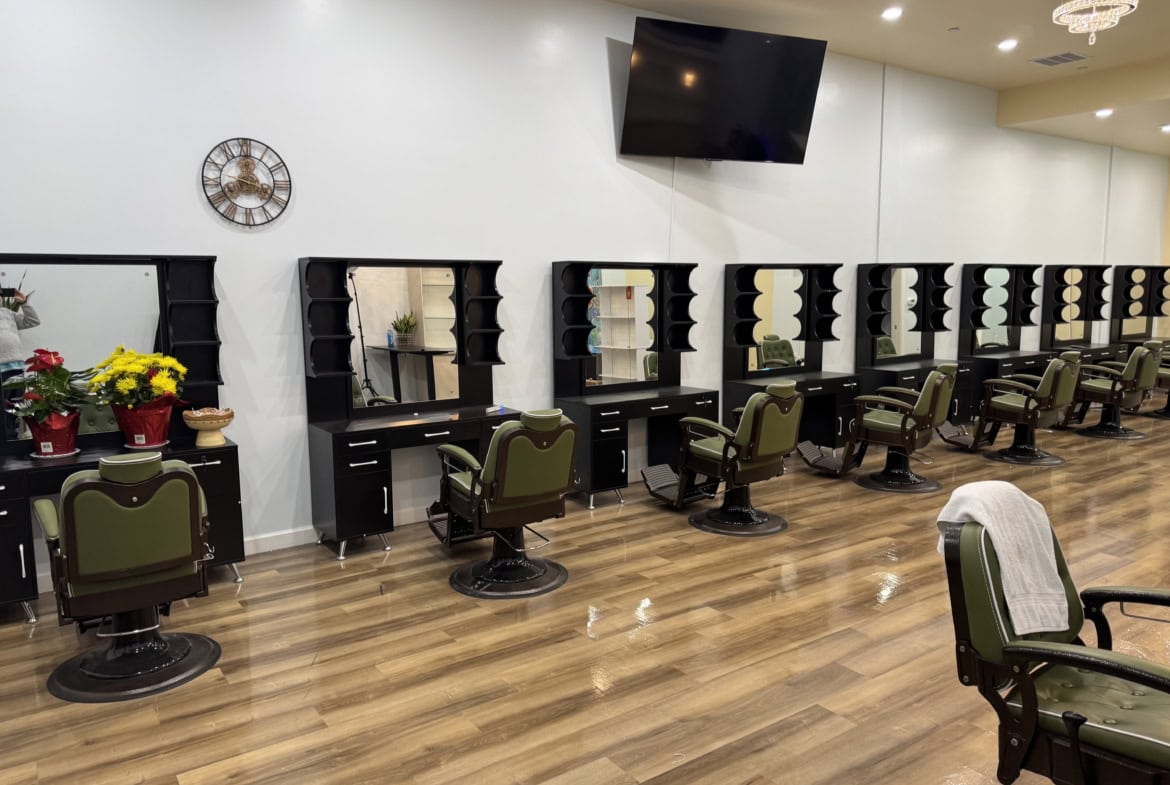Stylish salon stations with mirrors and chairs in a contemporary hair salon setting.