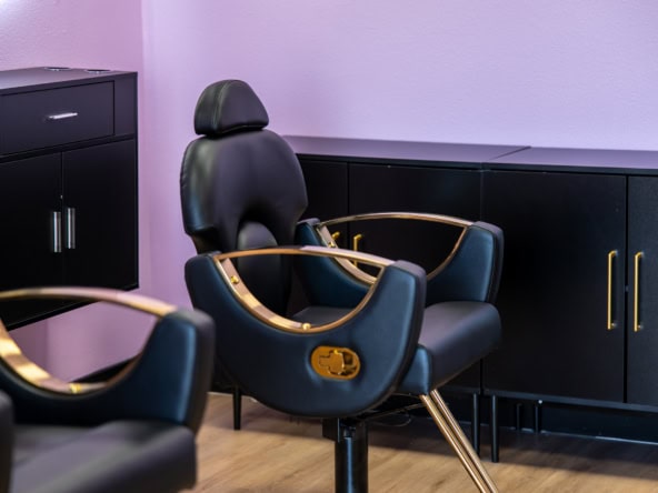 Styling chair and storage cabinets in a modern hair salon, ideal for rent or salon setup. Perfect fo.