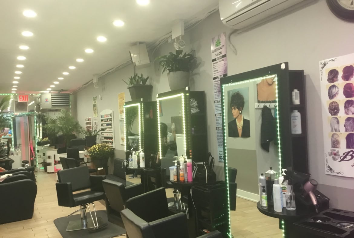 Stylish salon styling stations featuring LED mirrors, hair products, and comfortable chairs for prof.