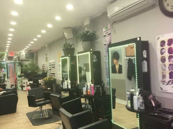 Stylish salon styling stations featuring LED mirrors, hair products, and comfortable chairs for prof.