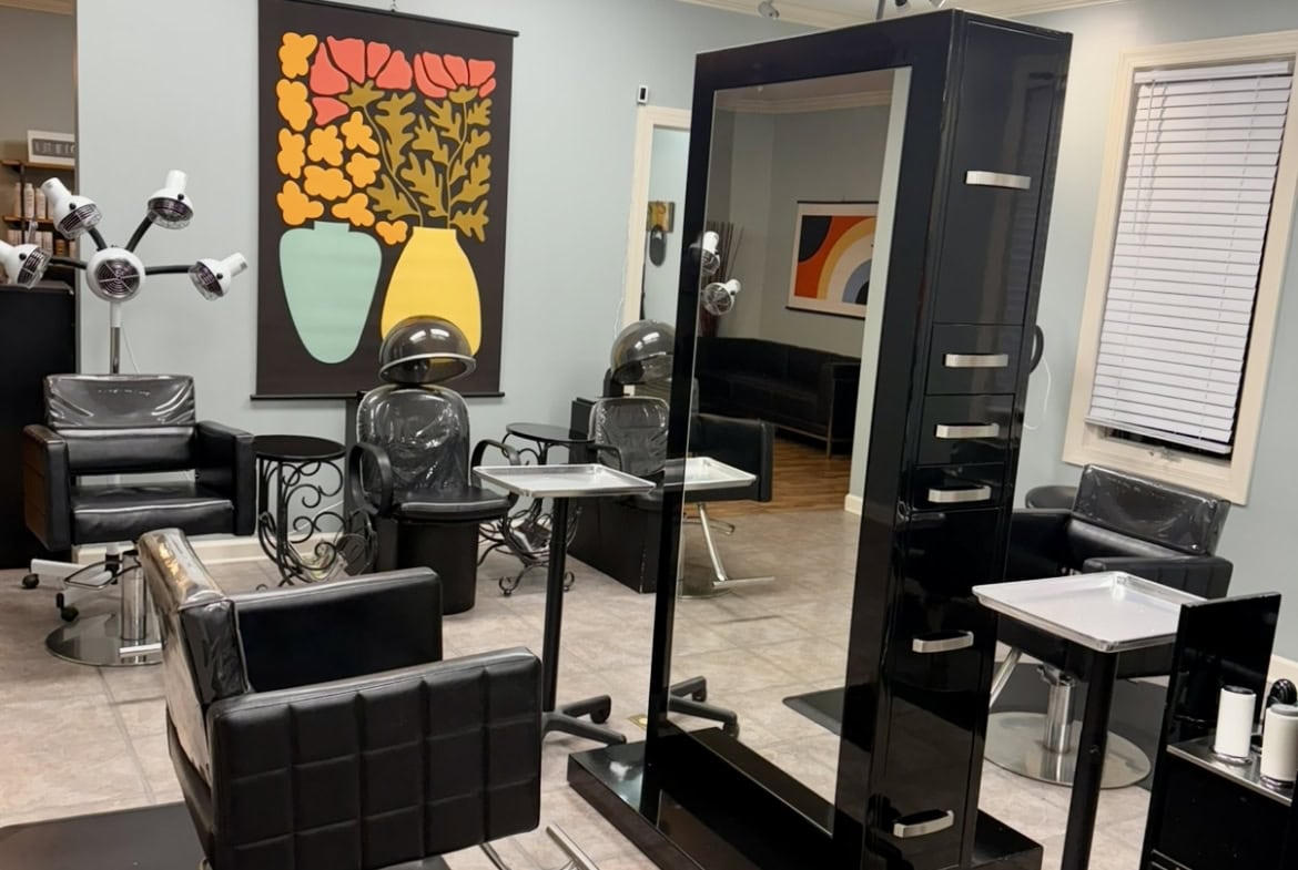 Modern salon styling station with hairdressing chairs, mirrors, and professional equipment for hairc.