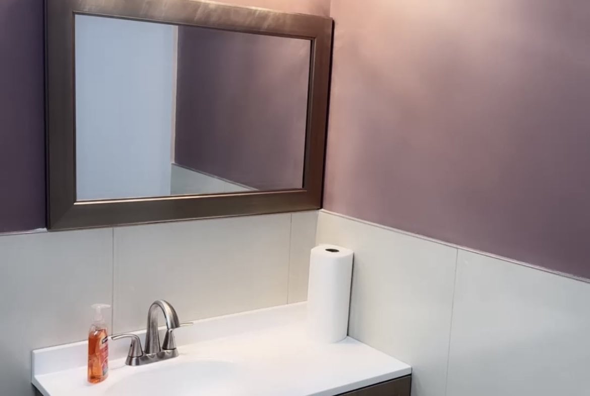 Bathroom vanity with mirror and lighting for salon professionals.