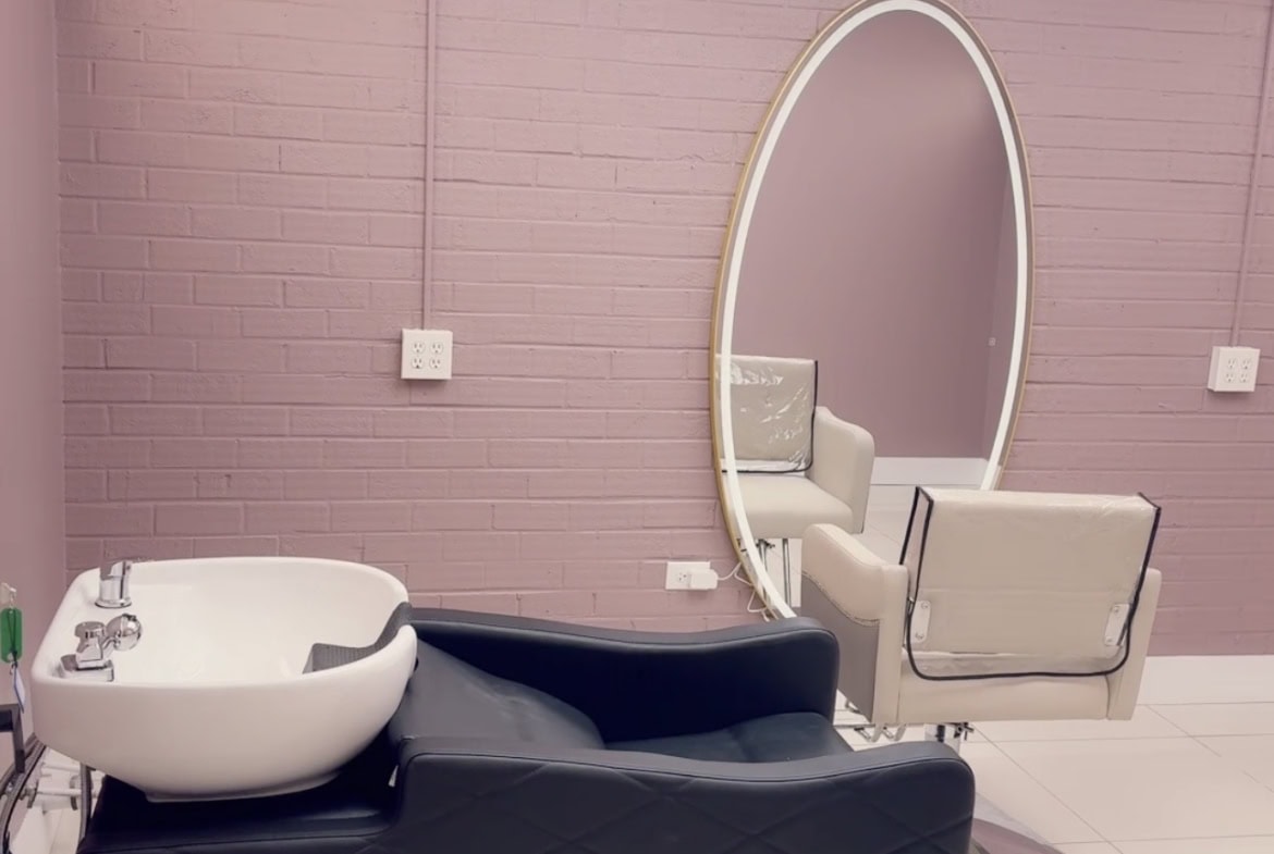 Modern salon station with mirror and pedicure chair for hair and beauty services.