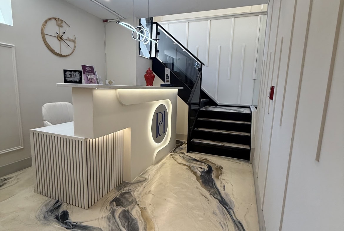 Modern salon reception area with sleek design and stylish decor.