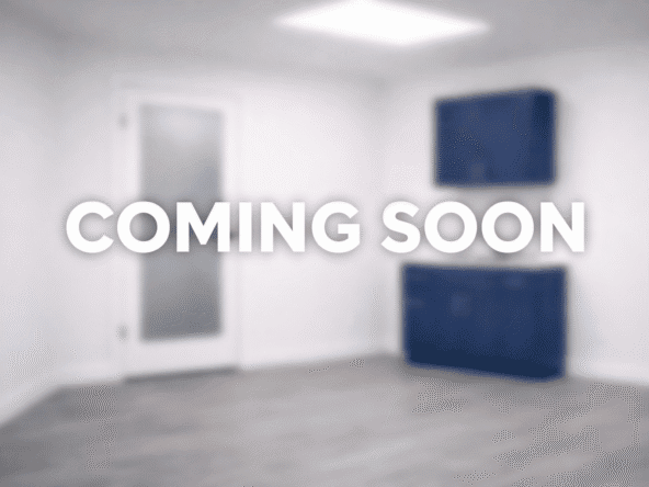 Empty salon room with blue cabinets, ready for new tenants.