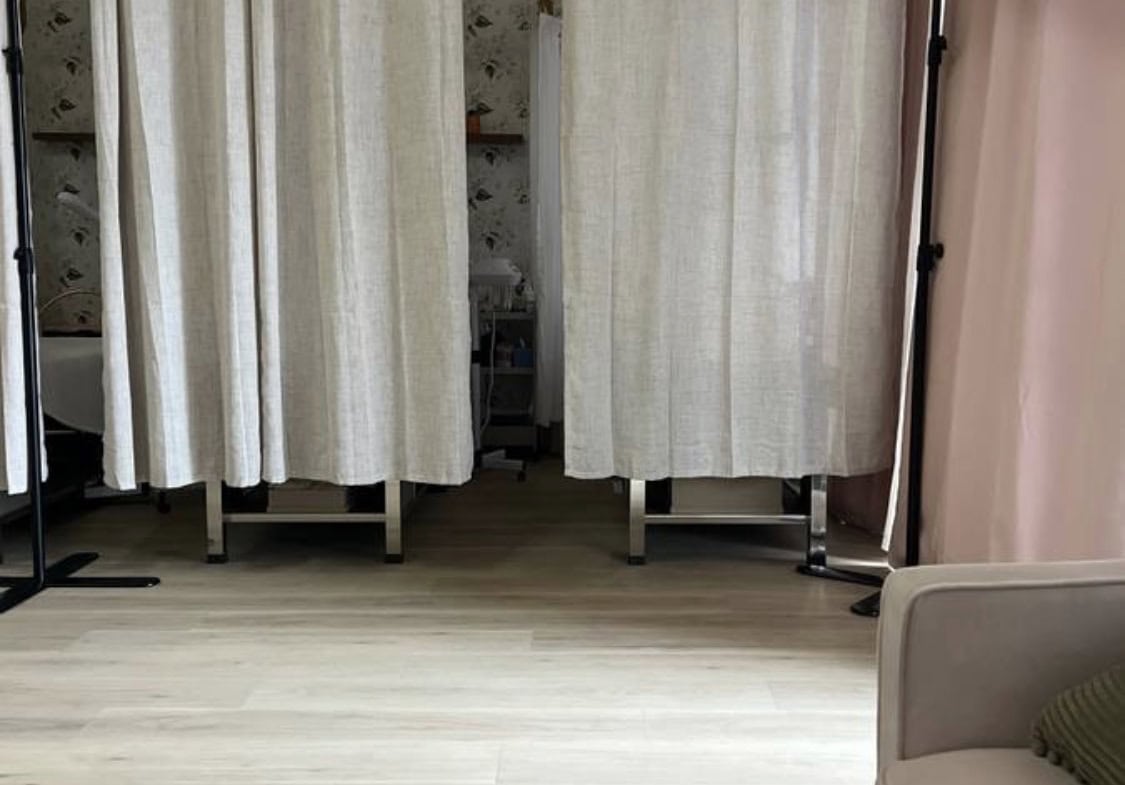 Private salon room with curtains for rent, ideal for beauty professionals seeking a private workspac.