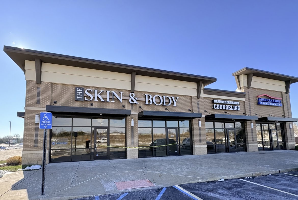 Modern storefront of Skin & Body wellness center in a shopping plaza.