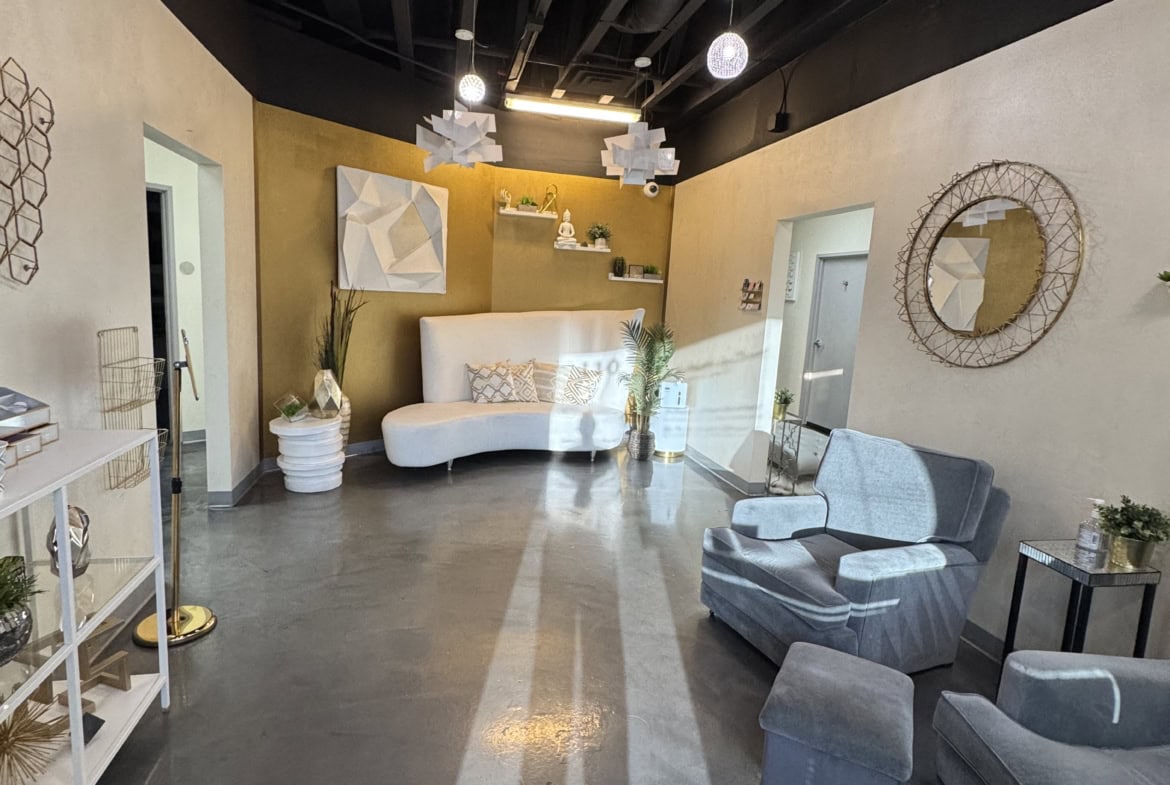Modern salon waiting area with stylish furniture and contemporary decor.
