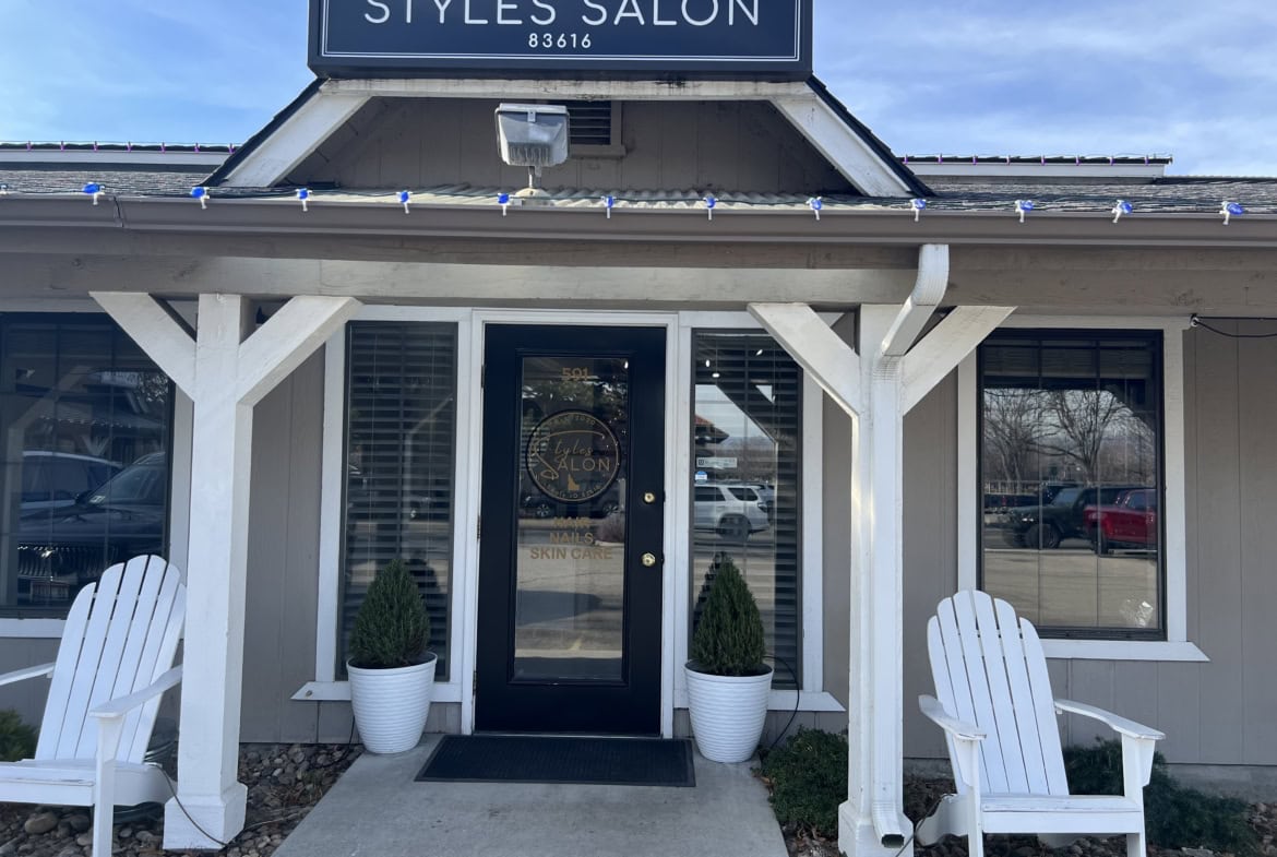 Exterior view of Styles Salon storefront with welcoming entrance and outdoor seating.