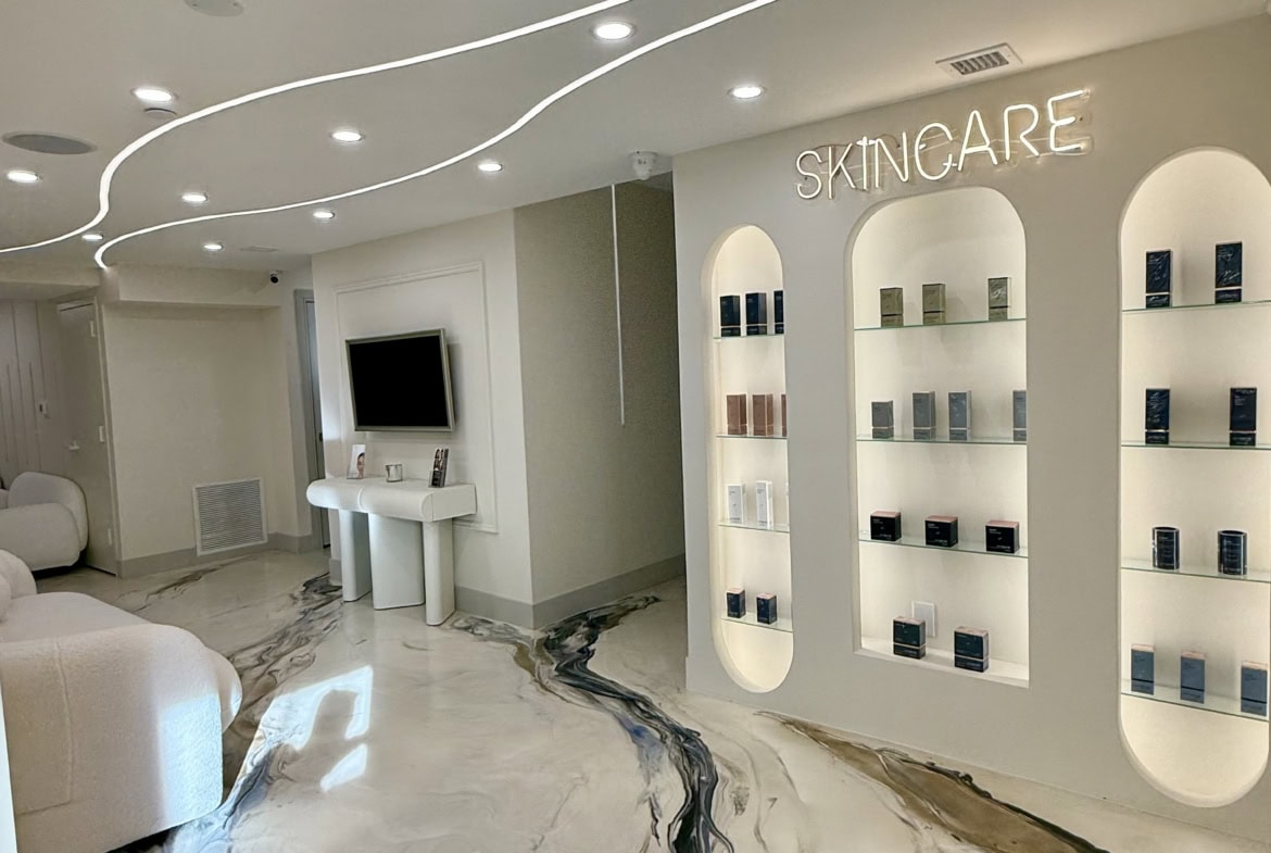 Interior of a skincare salon featuring sleek shelves, ambient lighting, and a clean, modern design.