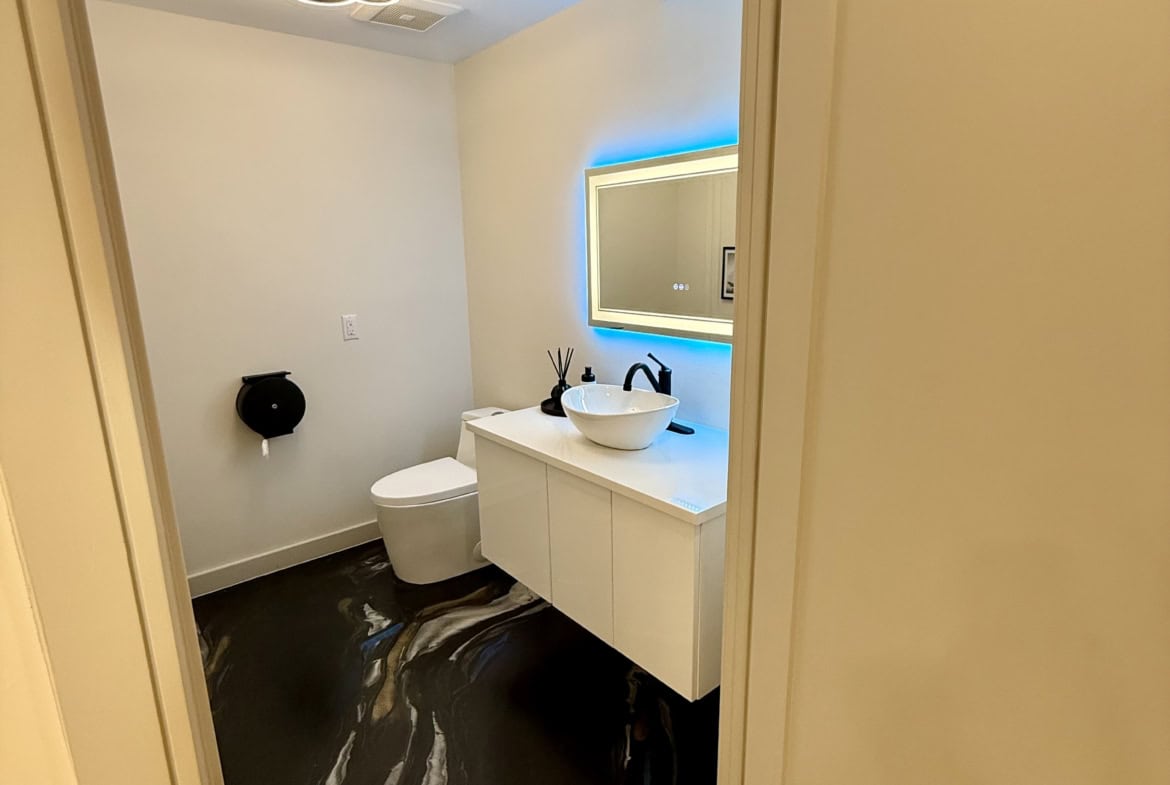 Salon restroom, modern design, ambient lighting, clean and stylish space.