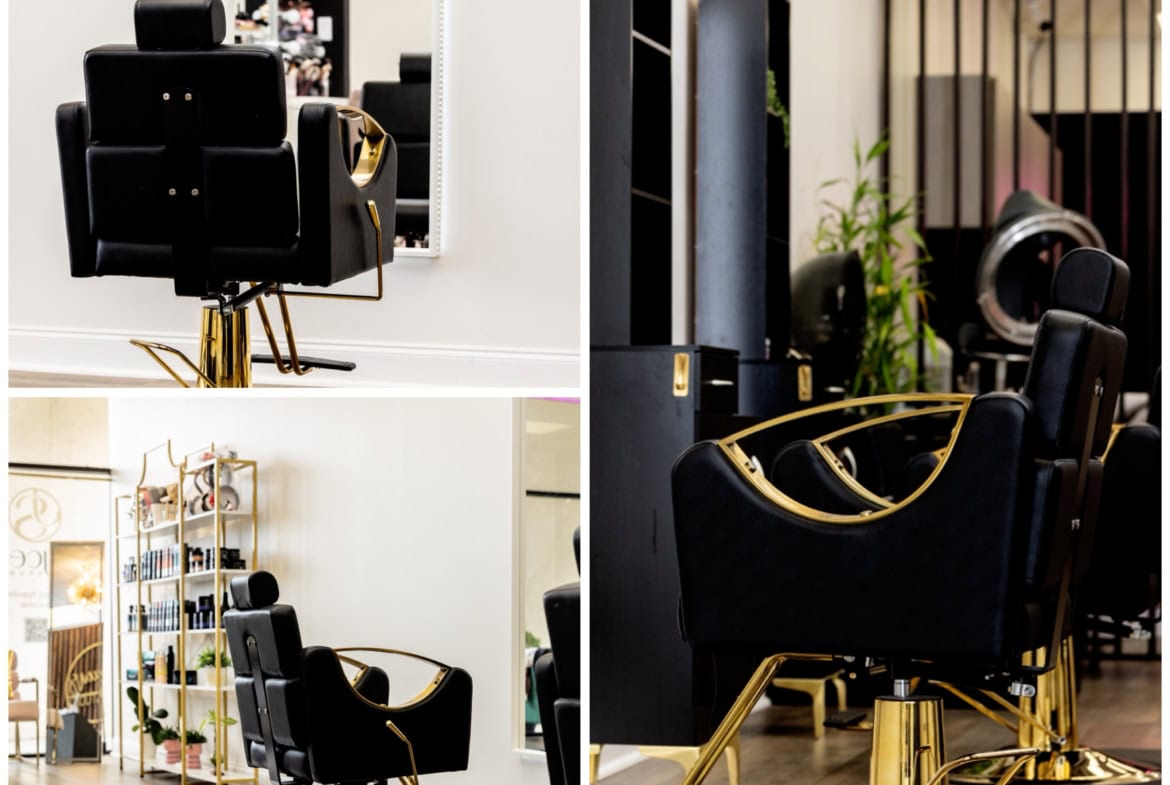 Stylish black salon chairs with gold accents in a modern hair salon setting.