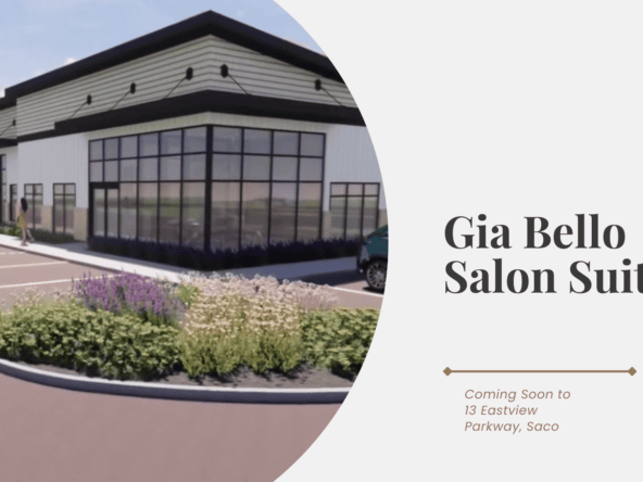 Modern salon building with large glass windows and parking lot.