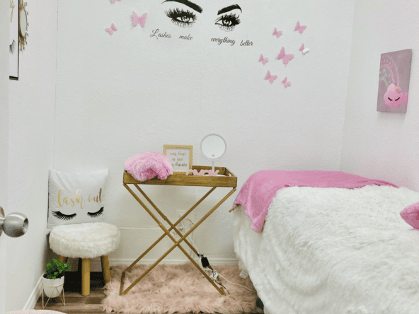 Beauty salon room with pink accents and butterfly decor.