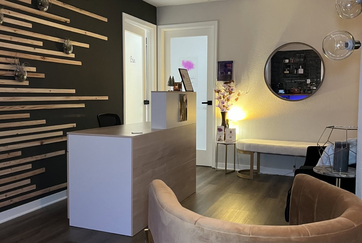Stylish salon reception with modern decor, cozy seating, and welcoming ambiance for clients.